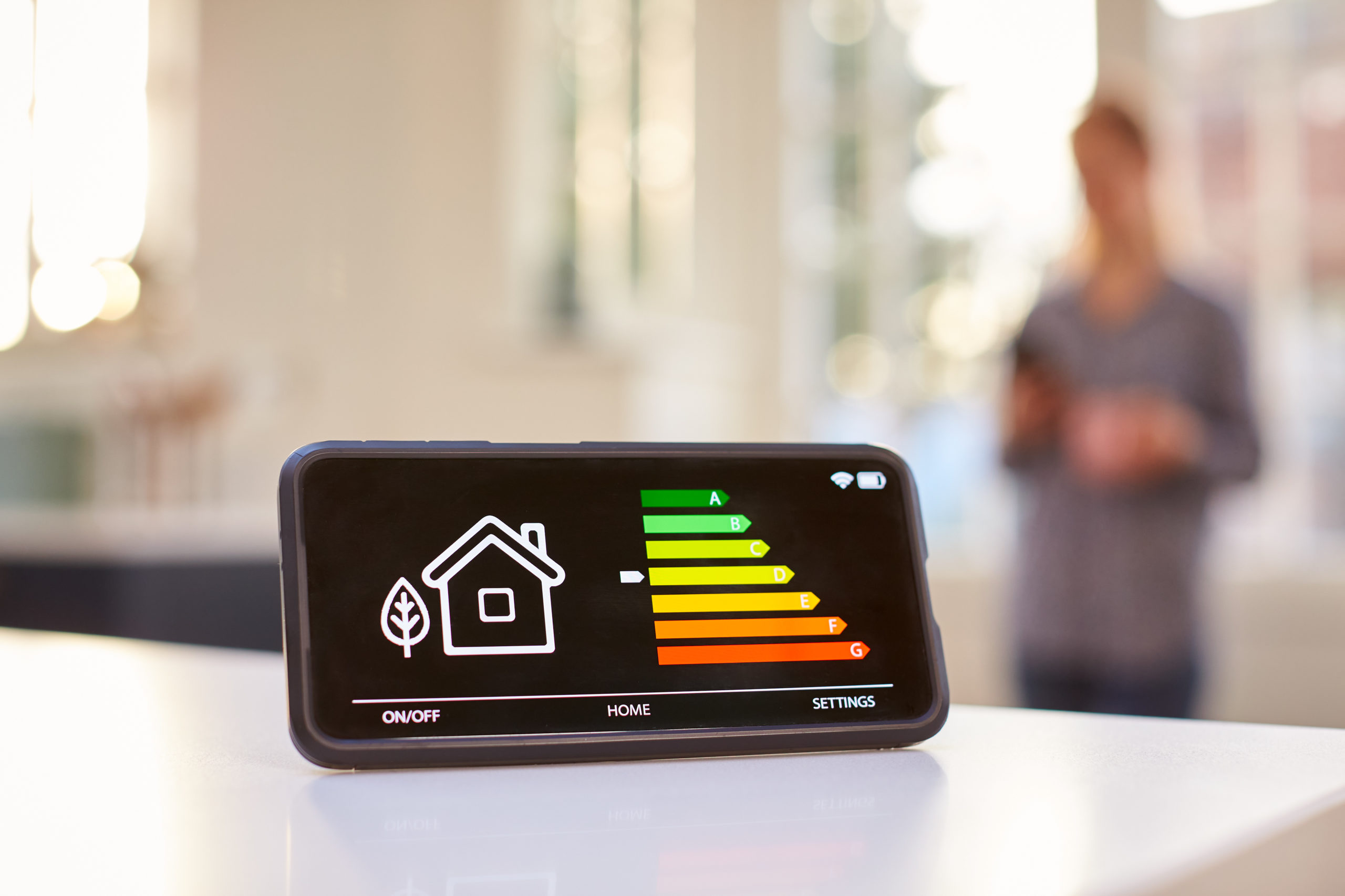 Tips for Making Your Home More Energy Efficient 1 Smart Energy Meter In Kitchen Measuring Energy Efficiency With Figure In Background